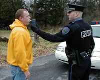 police officer administers a breathalyzer test